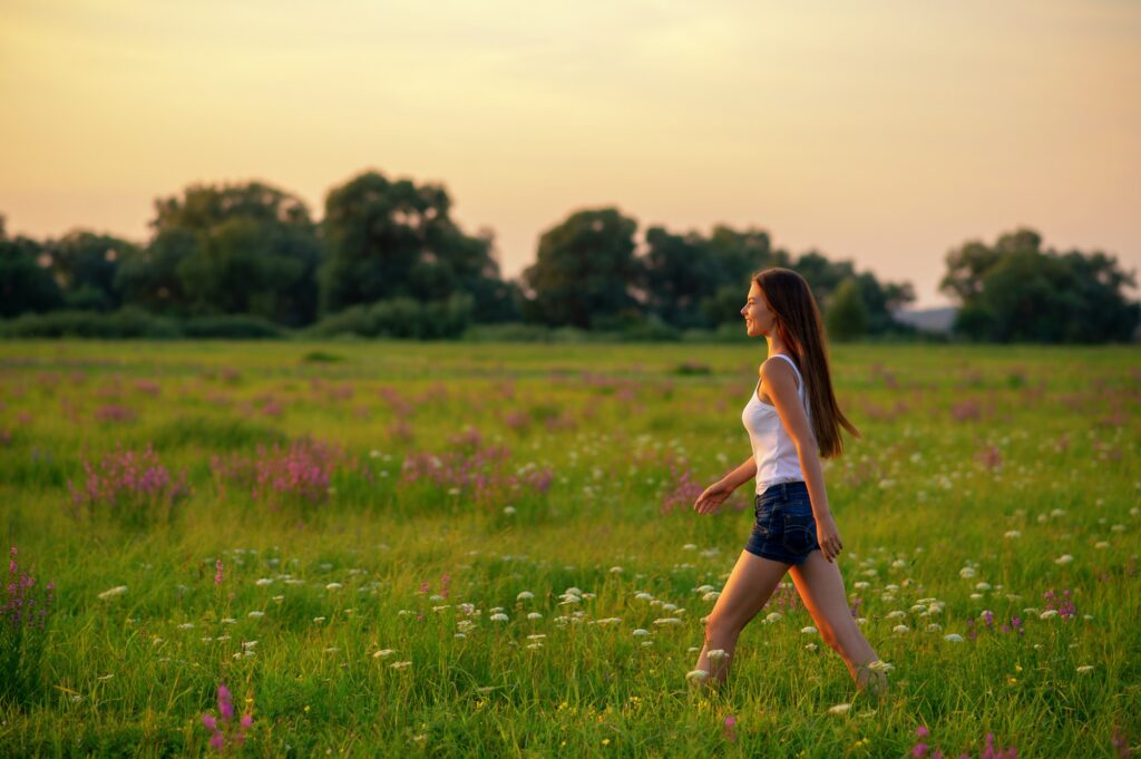 Young woman is walking on nature